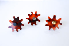 Close-up view of a single Splat drawer pull in faux tortoiseshell acrylic with a brass detail, highlighting its splat-shaped design and high-quality materials.
