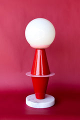 The Totem Lamp by Sazerac Stitches features geometric Bauhaus-inspired design in bold red and pink tones.