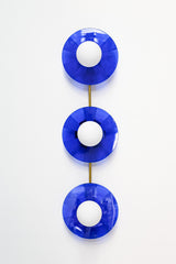 Bright Blue Triple Circus Sconce: Bold and dazzling, the Bright Blue Triple Circus Sconce captures the essence of Murano glass with its vibrant blue acrylic disc. Each intricately etched disc casts mesmerizing light and shadow patterns, transforming your walls into a captivating display.