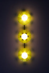 Neon Green Triple Circus Sconce: Steal the show with a touch of modern luxury! The Neon Green Triple Circus Sconce features three intricately etched green acrylic discs, drawing inspiration from the rich hues of Murano glass. Each disc casts mesmerizing light and shadow patterns, making this statement piece a true conversation starter.