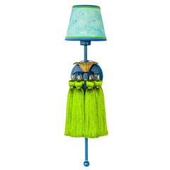 Close-up of the Tropical Tasseled Wall Sconce showing the sculpted antique brass flower detail, glossy lagoon blue backplate, and vibrant chartreuse green silk tassels. Perfect for eclectic, midcentury modern, and tropical-inspired interiors, this playful designer wall light adds texture, color, and artistic charm.