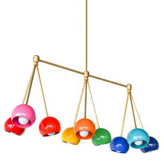 Brightly colored rainbow chandelier fixture with candy colored shades, brass hardware, and a long linear shape.  Beautiful and colorful statement lighting. Bright Rainbow Turmalina Chandelier by Sazerac Stitches - angled side view