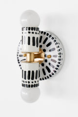 Handpainted black and white patterned wall sconce inspired by Greece & Portugal.  Maximalist style wall sconce that has a natural element because each one is hand-painted.  The painted thalia is a perfect small sconce that doubles as a statement light fixture because of the bold design.  Great for bathrooms, hallways, and more.