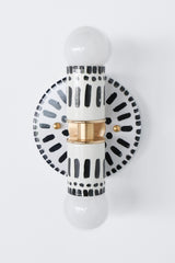 Handpainted black and white patterned wall sconce inspired by Greece & Portugal.  Maximalist style wall sconce that has a natural element because each one is hand-painted.  The painted thalia is a perfect small sconce that doubles as a statement light fixture because of the bold design.  Great for bathrooms, hallways, and more.