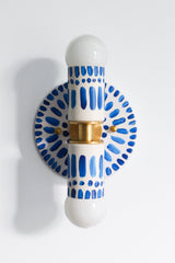 Handpainted blue and white patterned wall sconce inspired by Greece & Portugal.  Maximalist style wall sconce that has a natural element because each one is hand-painted.  The painted thalia is a perfect small sconce that doubles as a statement light fixture because of the bold design.  Great for bathrooms, hallways, and more.