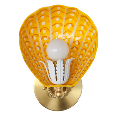 One-of-a-kind hand-painted shell-shaped wall sconce in yellow, orange, and white with glossy powdercoated steel shade and brass floral socket on white background – custom lighting made in New Orleans