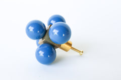 Denim Blue Ball-Cube Knob – A close-up of a modern brass knob featuring deep blue-grey glossy spheres, photographed on a white surface.
