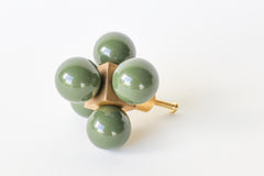 Olive Green Ball-Cube Knob – A geometric brass hardware piece featuring glossy olive green spheres, displayed on a white surface.