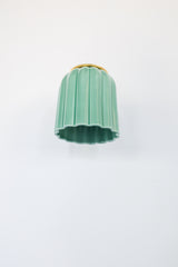 Glazed jade green ceramic Marcella sconce with fluted scalloped shade and brushed brass hardware; a handcrafted wall light ideal for bathrooms, powder rooms, or hallways in traditional, Southern, coastal, cottagecore, New England prep, grandmillennial, vintage-inspired, Art Deco, eclectic, or transitional interiors.