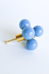 Hydrangea blue and brass oversized ball cube drawer pull shown on a white background; designed with five lacquered blue spheres arranged in a cube formation on a polished brass base, perfect for high-end interior hardware styling.