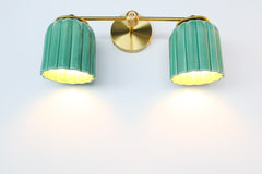 Designed for vanities, bathrooms, or hallways, the Double Marcella Sconce features bold jade green ceramic shades and timeless brass craftsmanship.
