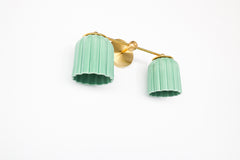 Modern yet classic, the Double Marcella Sconce in jade green and brass brings artisanal charm to bathrooms, living rooms, or bedside lighting. Ideal statement fixture with rich color and texture.