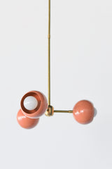 Peach & brass mid century modern style small chandelier with brass hardware and peach powdercoated glossy shade.  Adds a touch of color and style to any small space like a bedroom or bathroom.