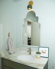 Neutral bathroom design with olive and brass accents