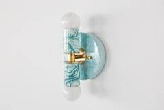 Hand-marbled modern two light wall sconce light fixture in pastel teal and.  Designed and made in New Orleans.  Colorful marbled lighting perfect for a maximalist bathroom, a pattern-loving interior designer, and more.  Each light fixture is unique.