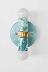 Hand-marbled modern two light wall sconce light fixture in pastel teal and.  Designed and made in New Orleans.  Colorful marbled lighting perfect for a maximalist bathroom, a pattern-loving interior designer, and more.  Each light fixture is unique.