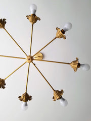 Brass floral chandelier mixes Victorian details with modern lines