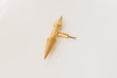 A brass double-ended spike handle from Sazerac Stitches, featuring two symmetrical pointed ends and a central mounting stem. This unique hardware piece has a bold, sculptural design, crafted from solid brass with a smooth, polished finish. Ideal for use as a decorative drawer pull, cabinet handle, or furniture accent, adding an edgy, modern touch to interiors. The warm golden hue of the brass patina enhances its vintage-inspired aesthetic.
