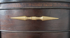 A brass double-ended spike handle from Sazerac Stitches, featuring two symmetrical pointed ends and a central mounting stem. This unique hardware piece has a bold, sculptural design, crafted from solid brass with a smooth, polished finish. Ideal for use as a decorative drawer pull, cabinet handle, or furniture accent, adding an edgy, modern touch to interiors. The warm golden hue of the brass patina enhances its vintage-inspired aesthetic.