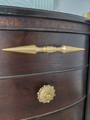 A brass double-ended spike handle from Sazerac Stitches, featuring two symmetrical pointed ends and a central mounting stem. This unique hardware piece has a bold, sculptural design, crafted from solid brass with a smooth, polished finish. Ideal for use as a decorative drawer pull, cabinet handle, or furniture accent, adding an edgy, modern touch to interiors. The warm golden hue of the brass patina enhances its vintage-inspired aesthetic.