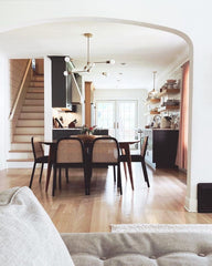Crisp white and wood modern home with a Brass annunciation chandelier by Sazerac Stitches