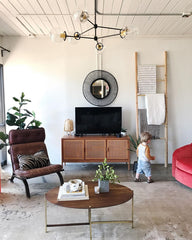 Eclectic Living room with  mid century modern furniture and a matte black chandelier by Sazerac Stitches