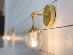 Brass West End sconces on white shiplap