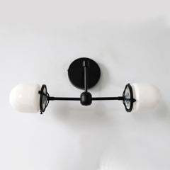 matte black modern two light wall sconce with white glass shades