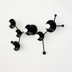 Matte Black modern light fixture in the shape of a sagittarius star constellation