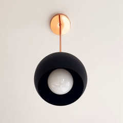 polished copper and matte black modern globe pendant