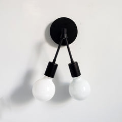 Black angular wall sconce taht can be used as accent lighting bedside lighting modern industrial inspired by Sazerac Stitches