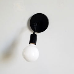 Simple black wall sconce for bathrooms, bedside lighting, etc.