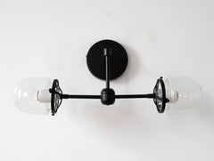 two light black sconce with clear shades for bathrooms
