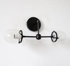 two light black sconce with clear shades for bathrooms
