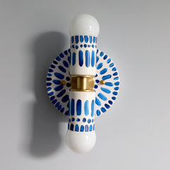 Handpainted blue and white patterned wall sconce inspired by Greece & Portugal.  Maximalist style wall sconce that has a natural element because each one is hand-painted.  The painted thalia is a perfect small sconce that doubles as a statement light fixture because of the bold design.  Great for bathrooms, hallways, and more.