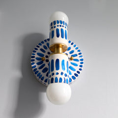Handpainted blue and white patterned wall sconce inspired by Greece & Portugal.  Maximalist style wall sconce that has a natural element because each one is hand-painted.  The painted thalia is a perfect small sconce that doubles as a statement light fixture because of the bold design.  Great for bathrooms, hallways, and more.