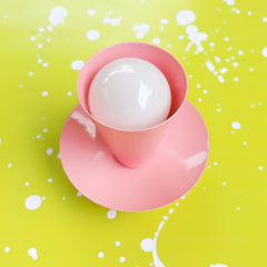 Pastel pink sconce or ceiling light fixture with a mid century modern style