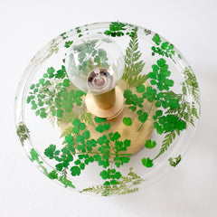 handmade flora wall sconce or flush mount ceiling light with shades of green, brass, and clear resin. bottom view
