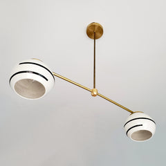black and white boho chandelier with brass accents and porcelain shades