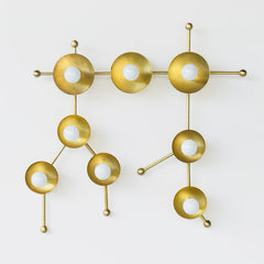 Brass sconce or flush mount ceiling light in the shape of  the Gemini constellation.  Astrology inspired light fixture - front view