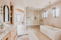 modern neutral and white bathroom with brass hardware details and Sazerac Stitches West end sconces