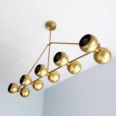 Brass modern chandelier with globe shades.  For oversized dining rooms or kitchen islands