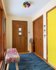 mid century modern hallway with rainbow flushmount ceiling light