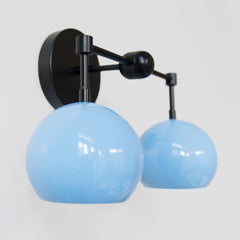 Mid Century modern two light wall sconce in pastel blue and black