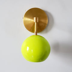 chartreuse green mid century modern wall sconce with brass accents