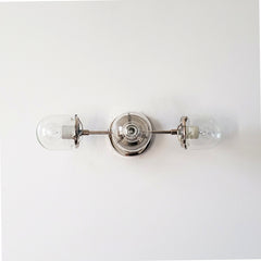 chrome and clear glass three light wall sconce for modern bathroom renovations