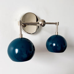 teal or lagoon blue two light wall sconce with mid century modern style is great for bathroom renovations