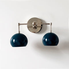 teal or lagoon blue two light wall sconce with mid century modern style is great for bathroom renovations