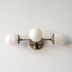 chrome and white three light wall sconce for bathroom vanities