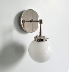 single chrome sconce with white globe shade